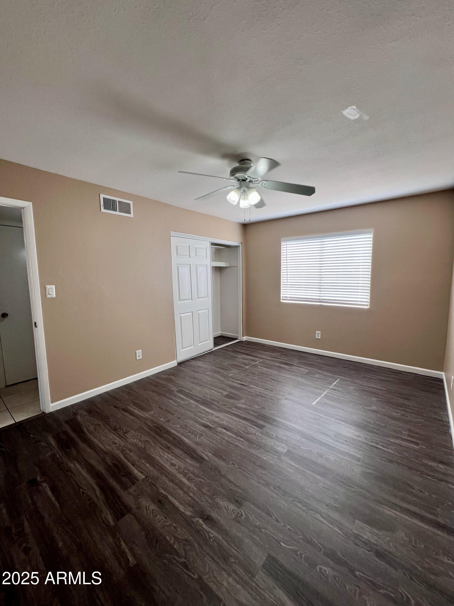 121 East Olive Avenue Gilbert, AZ 85234 - Photo 22 of 25 an empty room with wooden floor and window
