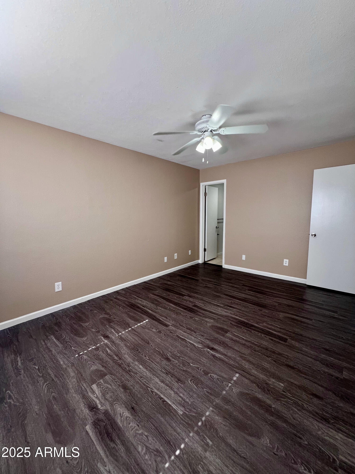 121 East Olive Avenue Gilbert, AZ 85234 - Photo 23 of 25 a view of an empty room with wooden floor