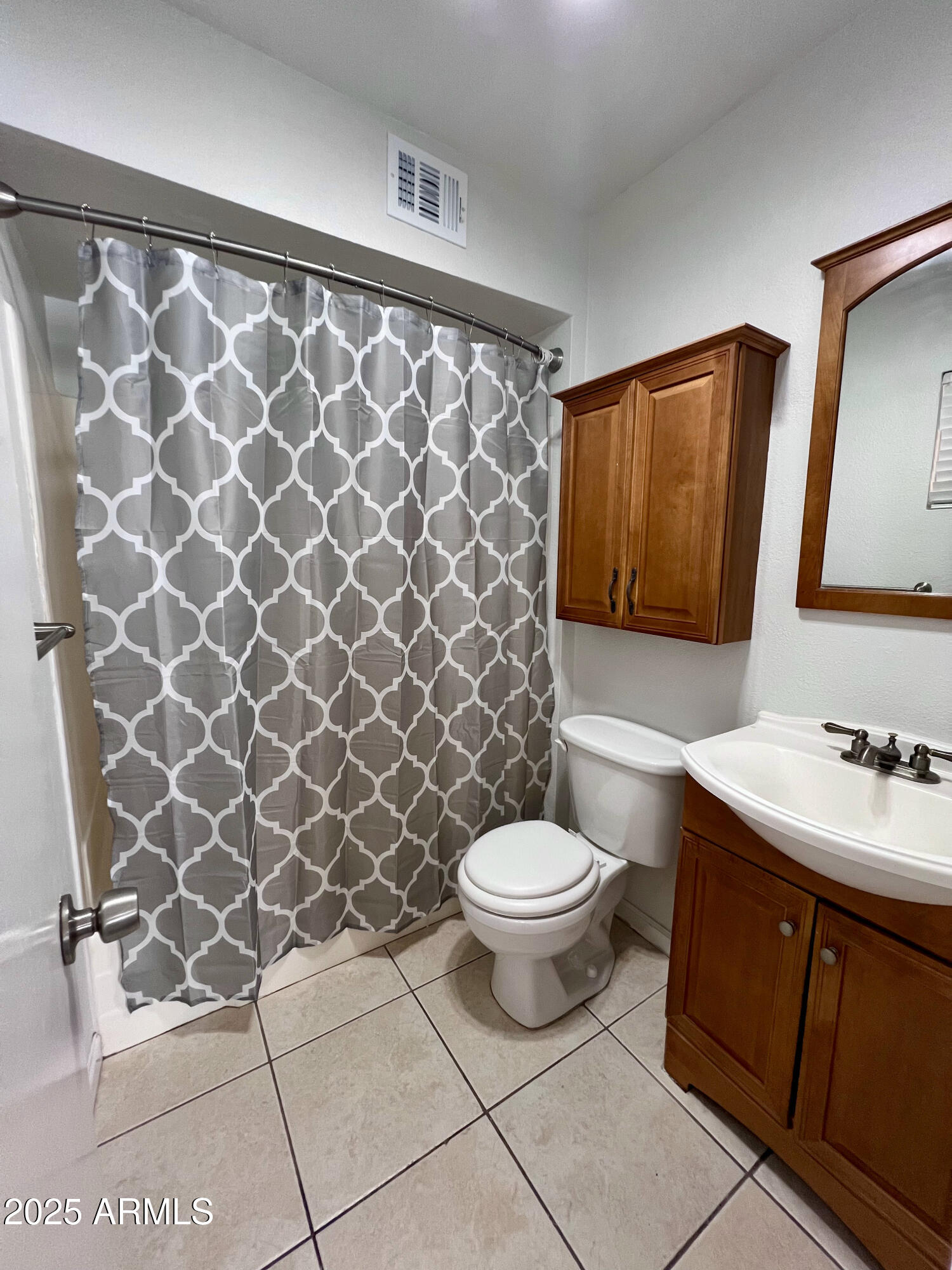 121 East Olive Avenue Gilbert, AZ 85234 - Photo 24 of 25 a bathroom with a toilet a sink and a mirror