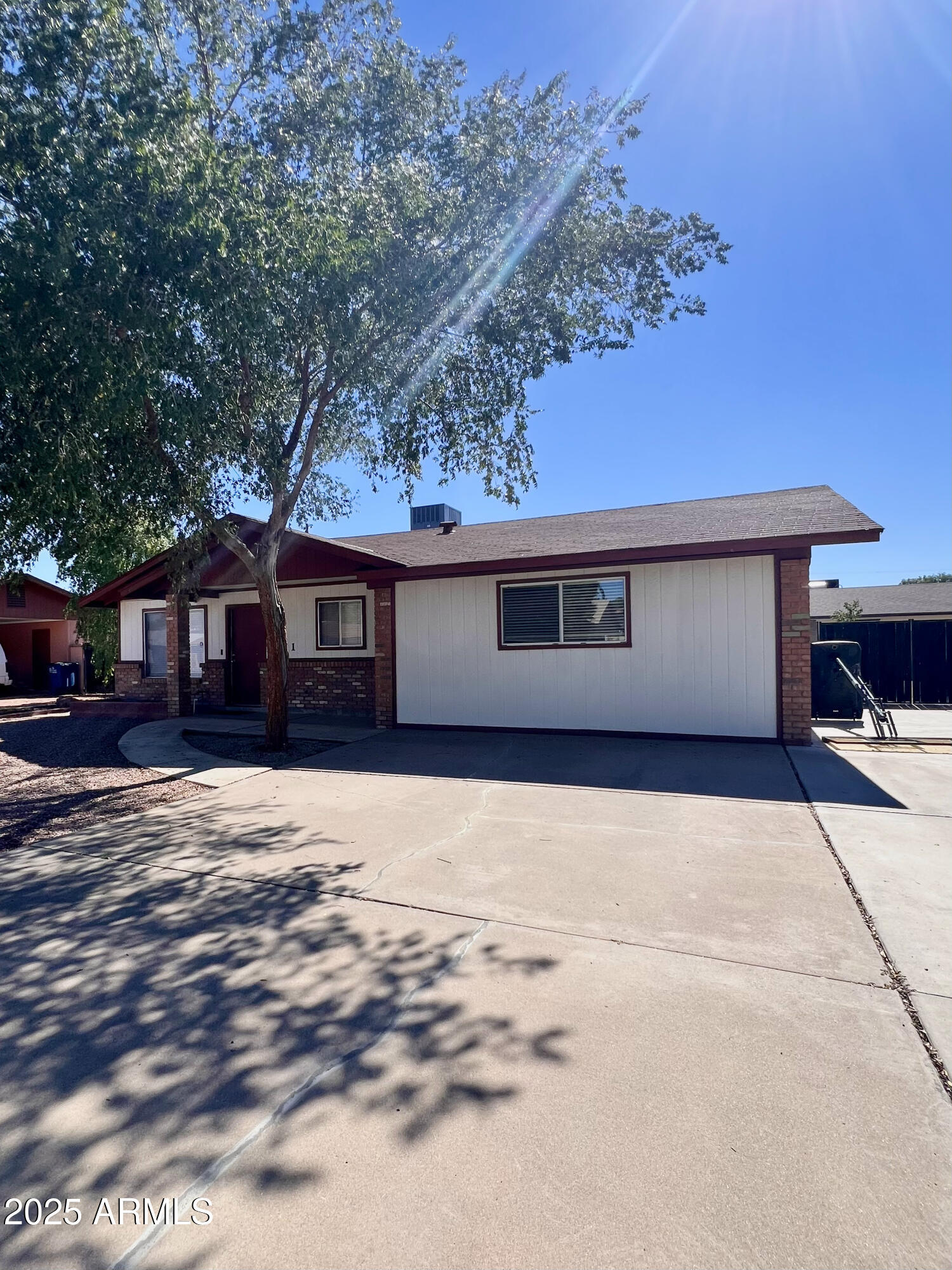 121 East Olive Avenue Gilbert, AZ 85234 - Photo 5 of 25 a front view of a house with a yard and garage