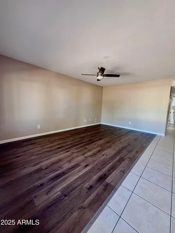 a view of a room with an empty space and wooden floor