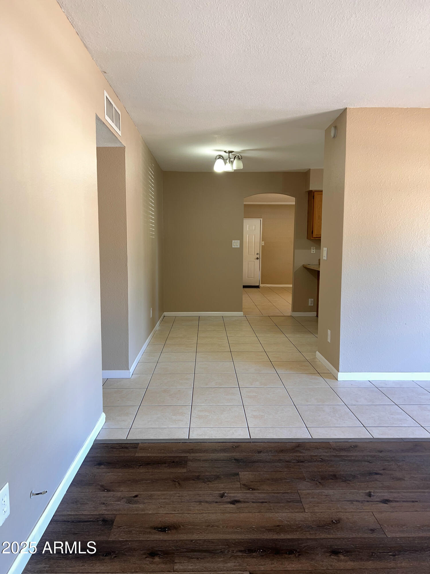 121 East Olive Avenue Gilbert, AZ 85234 - Photo 8 of 25 a view of an empty room with wooden floor and a window