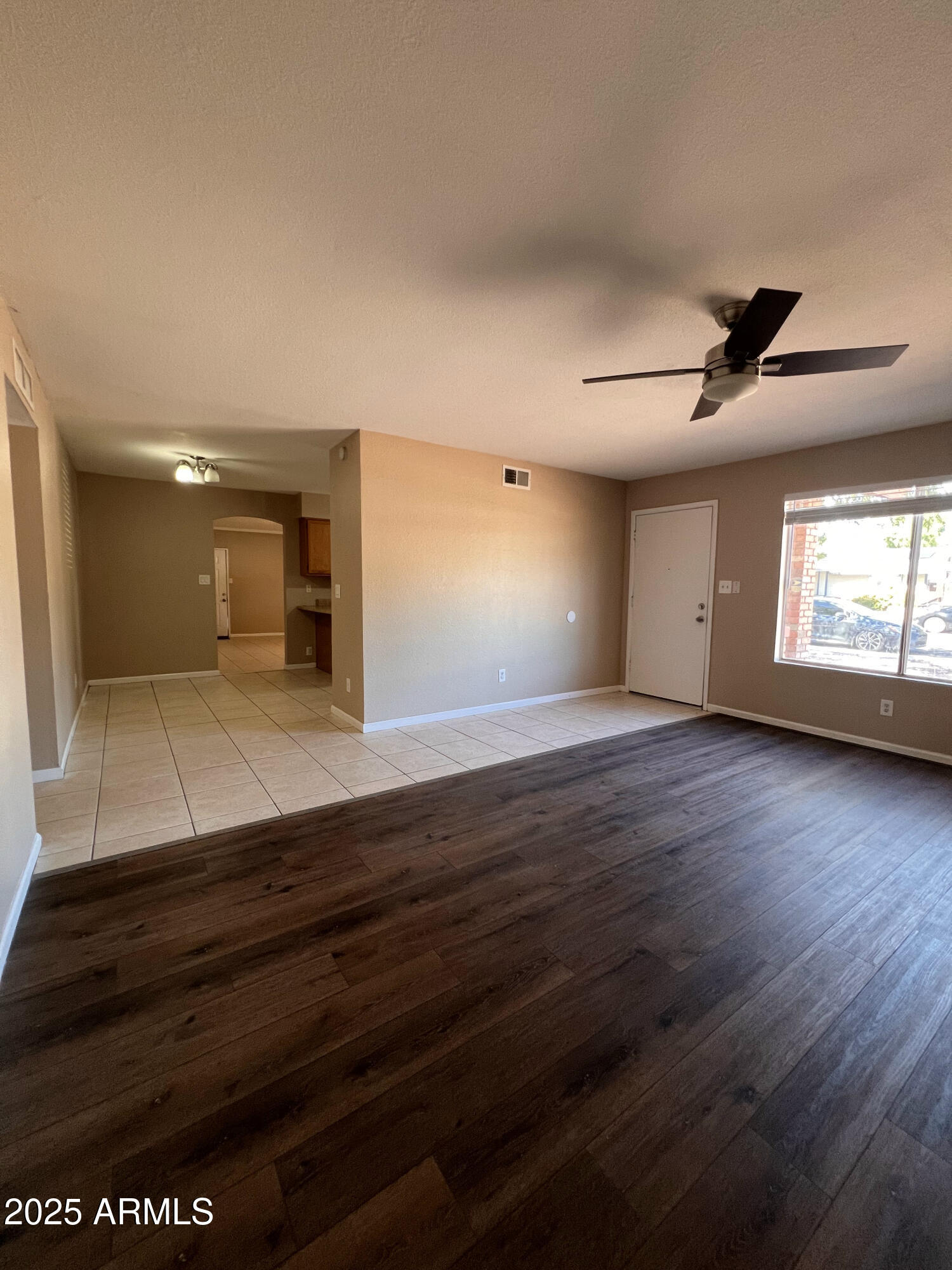 121 East Olive Avenue Gilbert, AZ 85234 - Photo 10 of 25 a view of empty room with wooden floor and fan