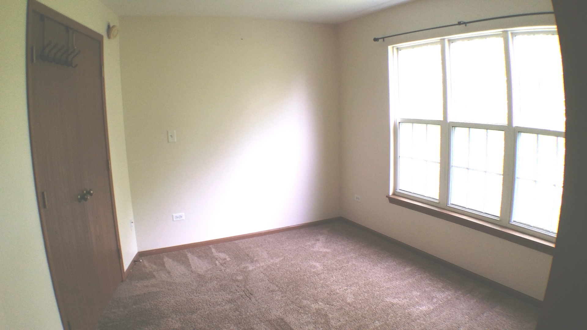 1934 Heron Avenue, Unit D Schaumburg, IL 60193 - Photo 11 of 20 an empty room with a window