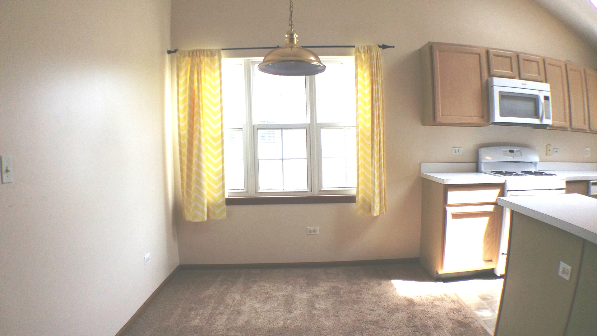 1934 Heron Avenue, Unit D Schaumburg, IL 60193 - Photo 5 of 20 a view of an empty room with a window