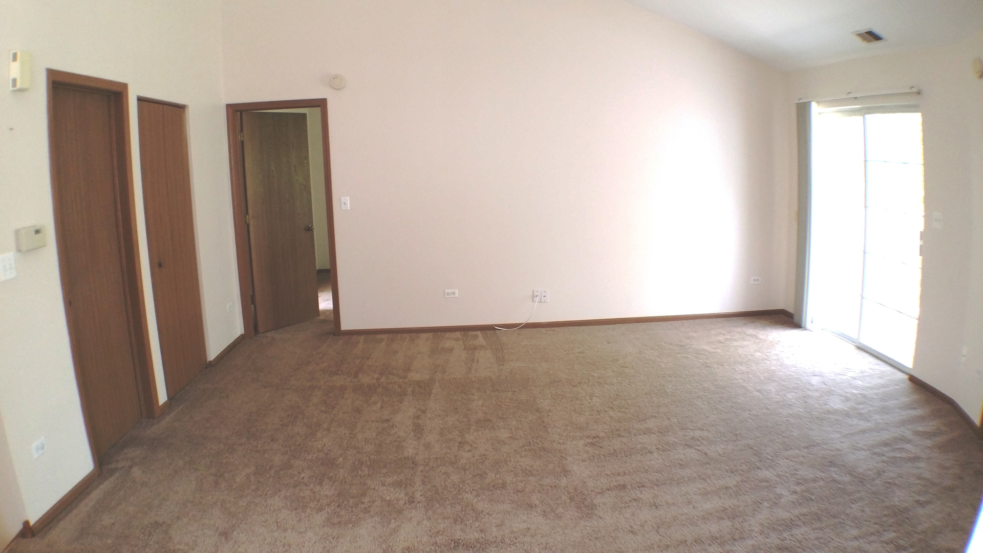 1934 Heron Avenue, Unit D Schaumburg, IL 60193 - Photo 7 of 20 an empty room with windows