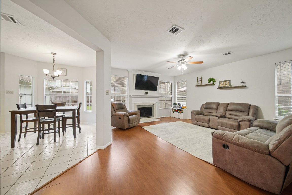 16114 Kintyre Point Road Houston, TX 77095 - Photo 17 of 41 a living room with furniture a fireplace and a flat screen tv