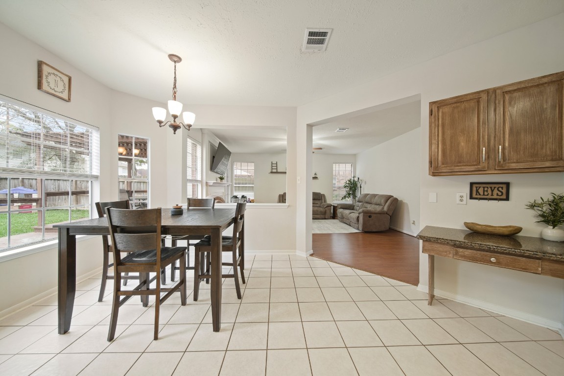 16114 Kintyre Point Road Houston, TX 77095 - Photo 21 of 41 a kitchen with granite countertop a table and chairs in it