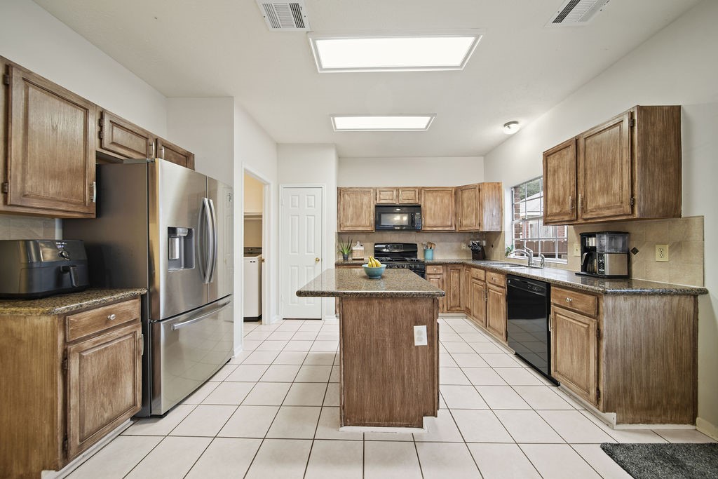 16114 Kintyre Point Road Houston, TX 77095 - Photo 22 of 41 a kitchen with stainless steel appliances granite countertop a refrigerator stove microwave and sink