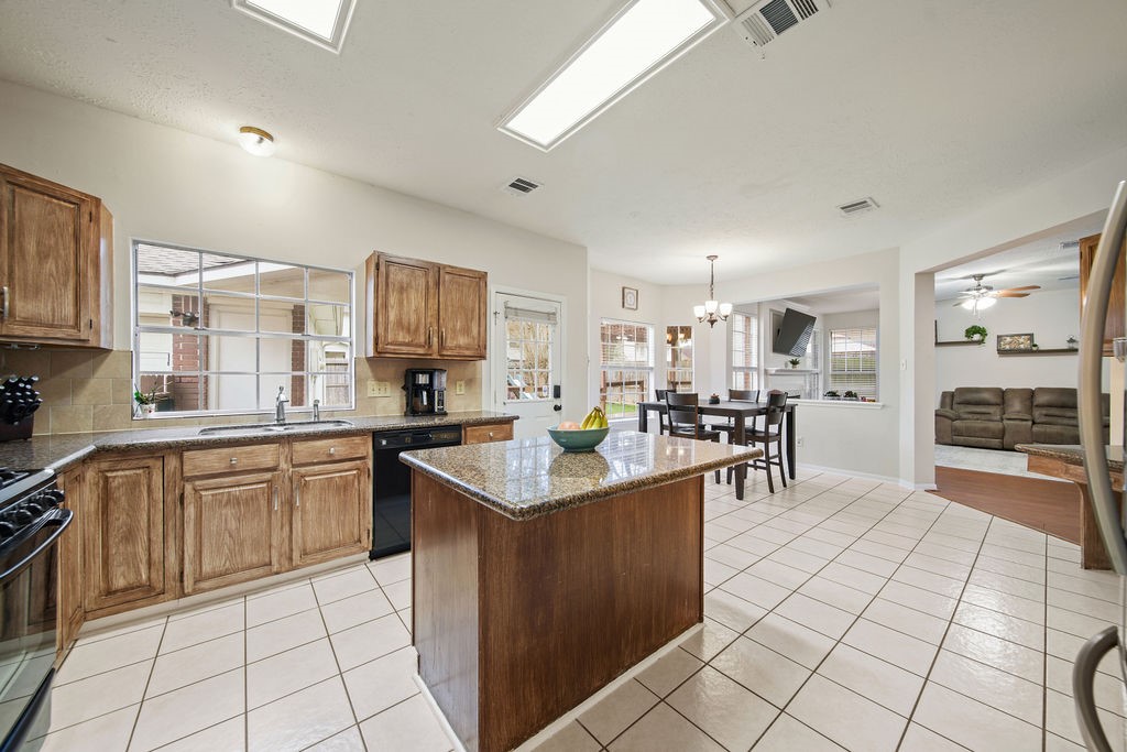 16114 Kintyre Point Road Houston, TX 77095 - Photo 26 of 41 a kitchen with stainless steel appliances granite countertop a stove top oven a sink a counter top space and cabinets