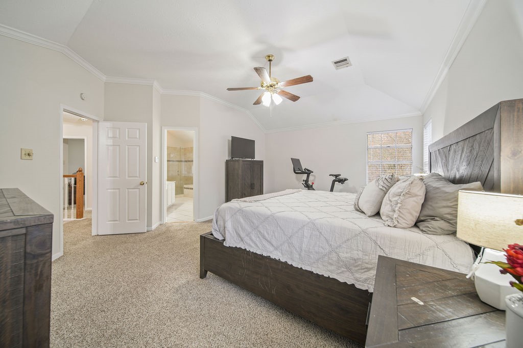16114 Kintyre Point Road Houston, TX 77095 - Photo 30 of 41 a spacious bedroom with a bed and a ceiling fan