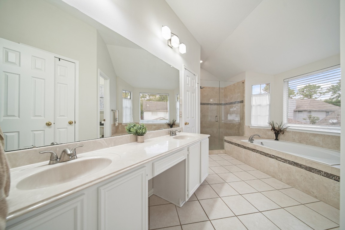 16114 Kintyre Point Road Houston, TX 77095 - Photo 31 of 41 a large bathroom with a double vanity sink mirror and bathtub