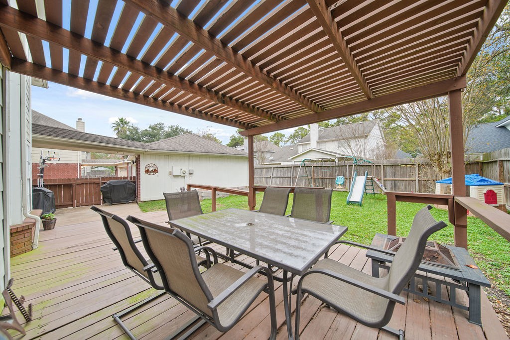 16114 Kintyre Point Road Houston, TX 77095 - Photo 38 of 41 a view of a patio with table and chairs under an umbrella with a barbeque grill