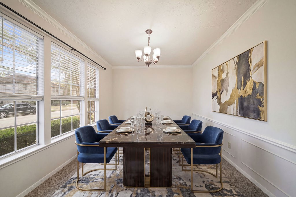 16114 Kintyre Point Road Houston, TX 77095 - Photo 9 of 41 a view of a dining room with furniture wooden floor and a chandelier