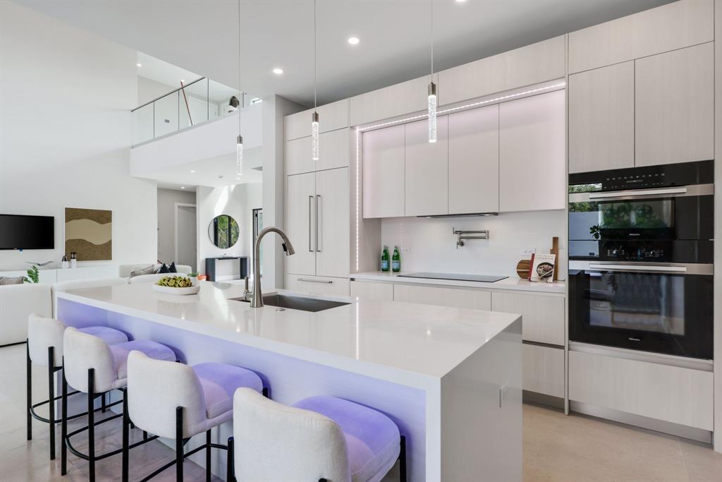 2015 Northeast 4th Avenue Wilton Manors, FL 33305 - Photo 22 of 79 a kitchen with a sink refrigerator and cabinets