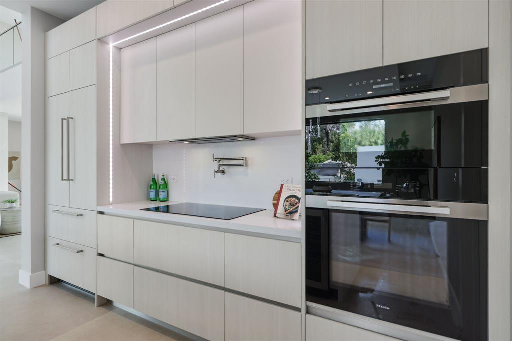 2015 Northeast 4th Avenue Wilton Manors, FL 33305 - Photo 23 of 79 a kitchen with white cabinets and window