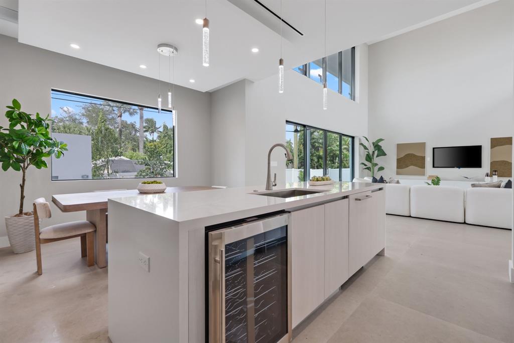 2015 Northeast 4th Avenue Wilton Manors, FL 33305 - Photo 24 of 79 a kitchen with white cabinets and white appliances