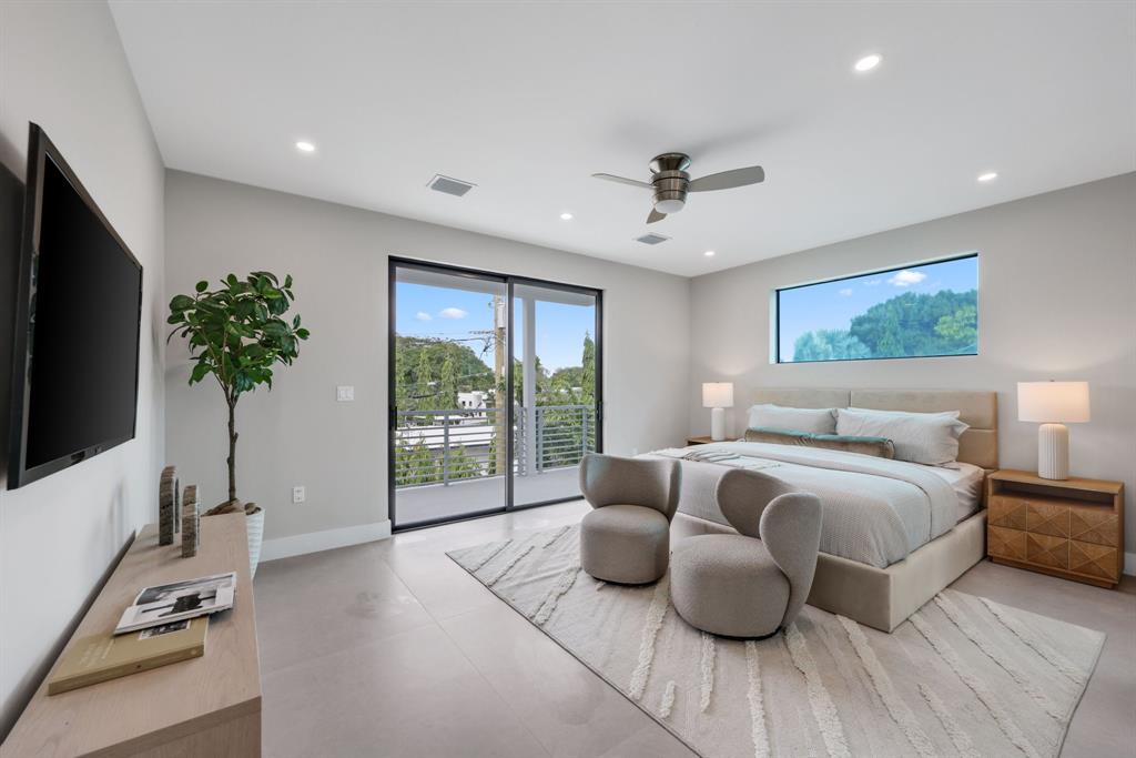 2015 Northeast 4th Avenue Wilton Manors, FL 33305 - Photo 44 of 79 a spacious bedroom with bed and a flat screen tv
