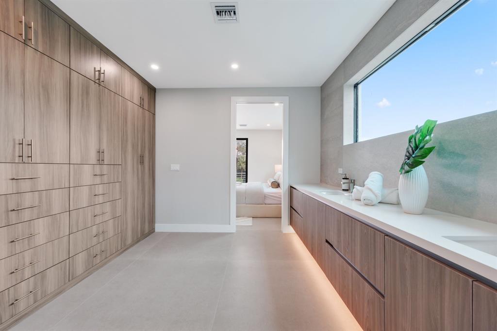2015 Northeast 4th Avenue Wilton Manors, FL 33305 - Photo 47 of 79 a bathroom with a double vanity sink and a mirror