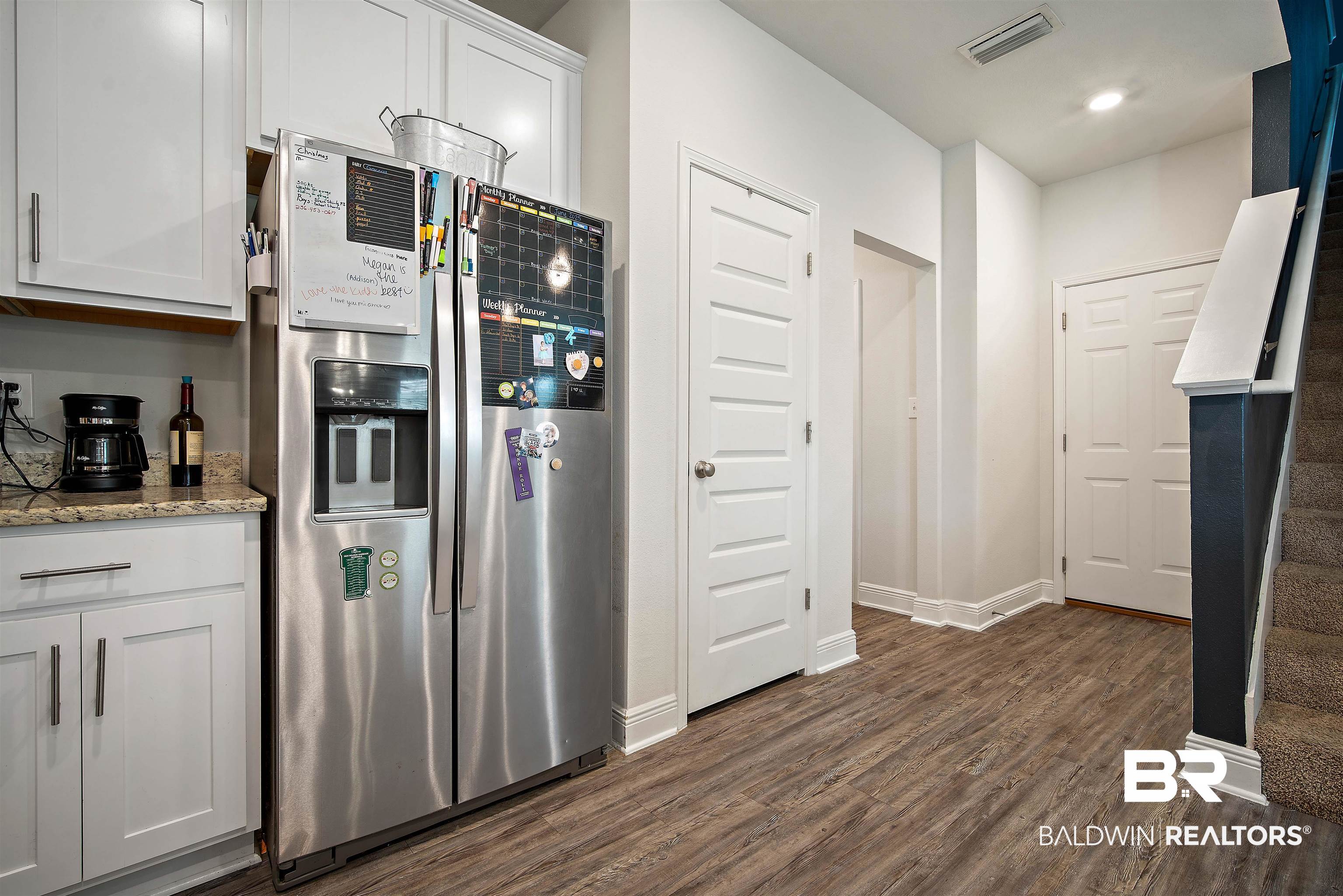 24341 Alydar Loop Daphne, AL 36526 - Photo 13 of 45 Kitchen featuring stainless steel fridge, dark wood-style flooring, white cabinets, light stone countertops, and recessed lighting