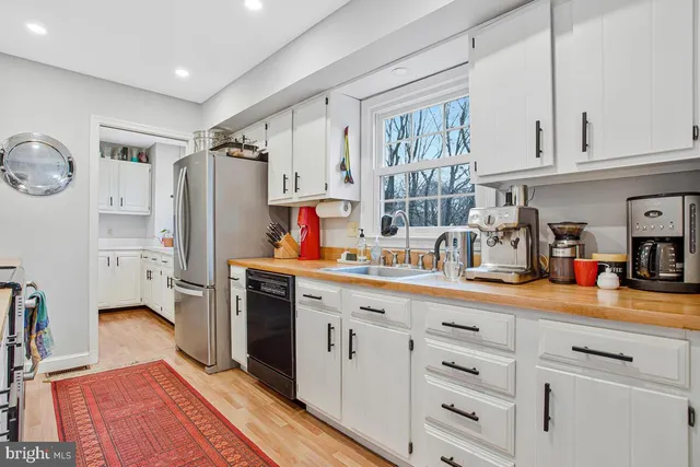 a kitchen with stainless steel appliances a sink stove and cabinets