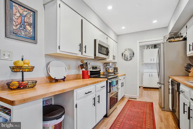 a kitchen with stainless steel appliances a stove a microwave and cabinets