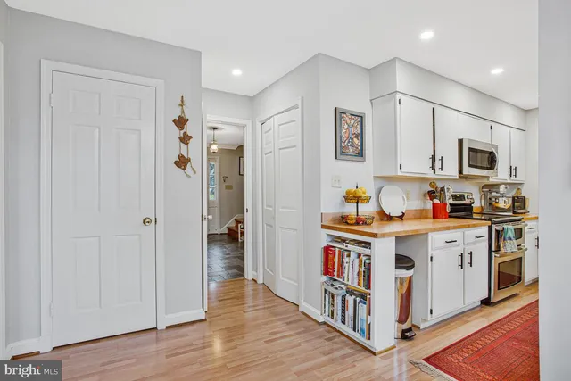 a view of a dining room with furniture and a chandelier