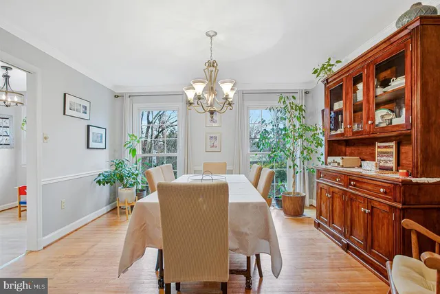 a view of a dining room with furniture and chandelier