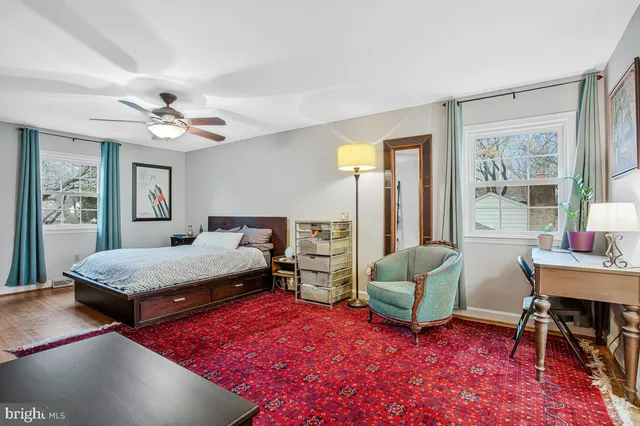 a bedroom with a bed and a flat tv screen on dresser