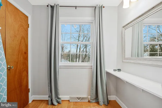 a bathroom with a sink vanity mirror and toilet