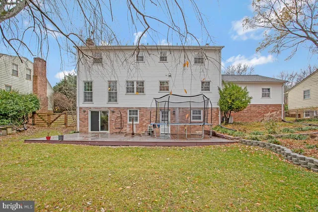 a front view of a house with swimming pool and sitting area