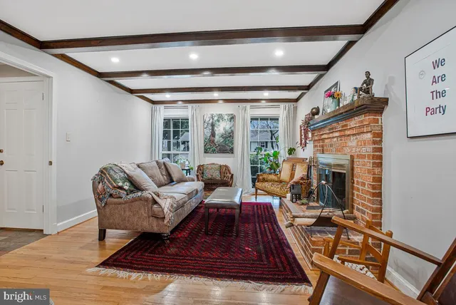 a living room with furniture fireplace and rug
