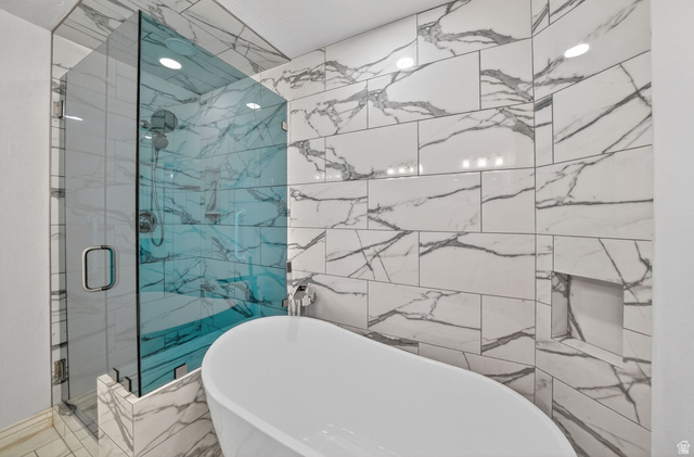 6969 South 855 East Midvale, UT 84047 - Photo 8 of 55 Modern bathroom featuring a freestanding soaking tub and a spacious glass-enclosed shower