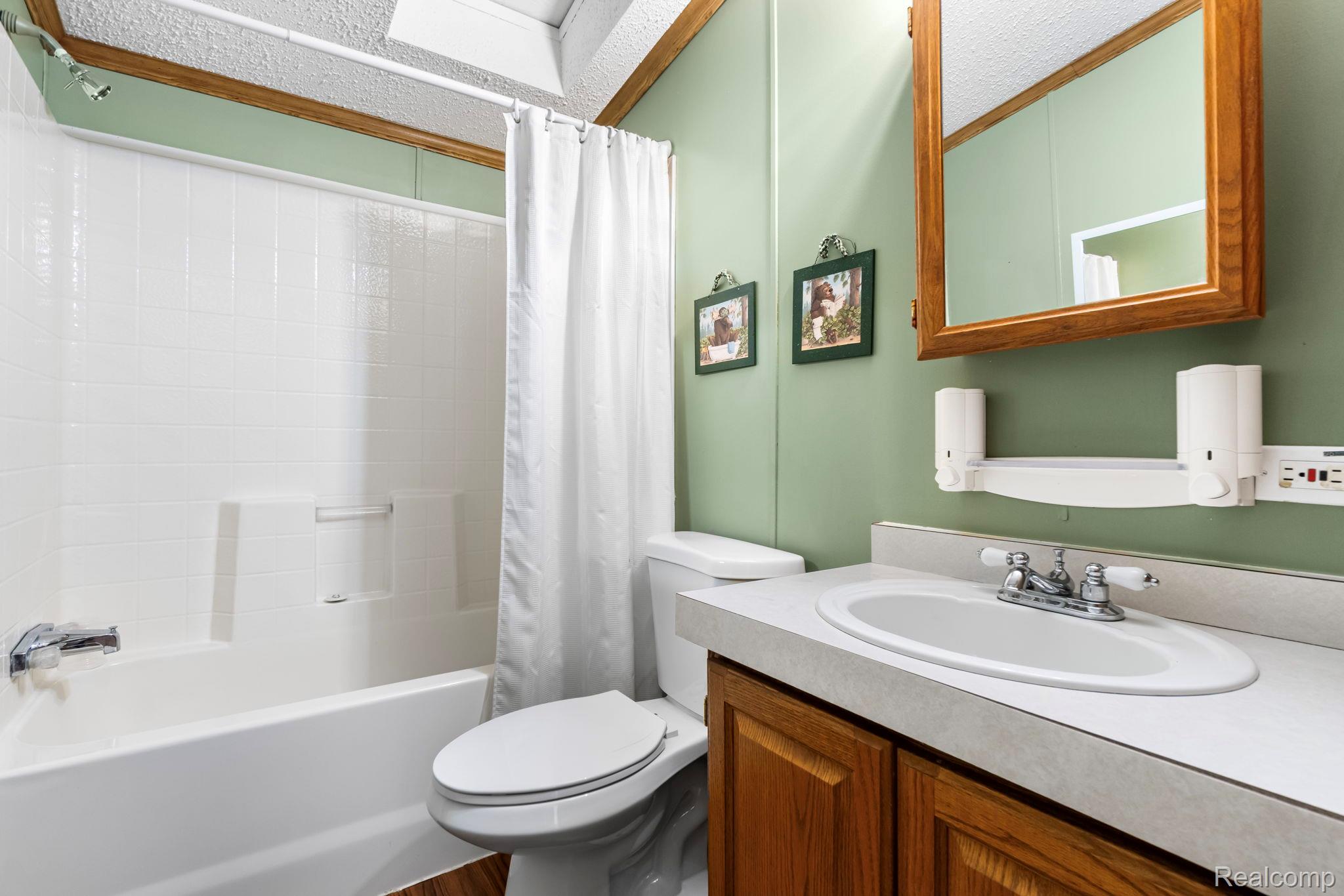 4884 Griffin Road Lewiston, MI 49756 - Photo 24 of 41 White subway tile shower surround with a built-in tub