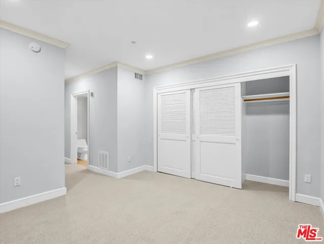 a bathroom with a shower sink mirror and toilet