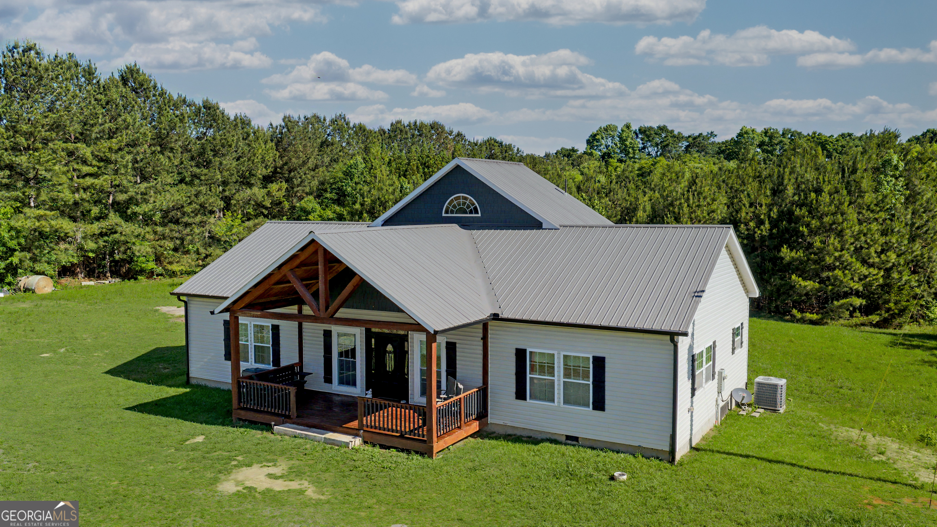 213 Fredonia Church Road Barnesville, GA 30204 - Photo 1 of 32 an aerial view of a house with swimming pool and garden