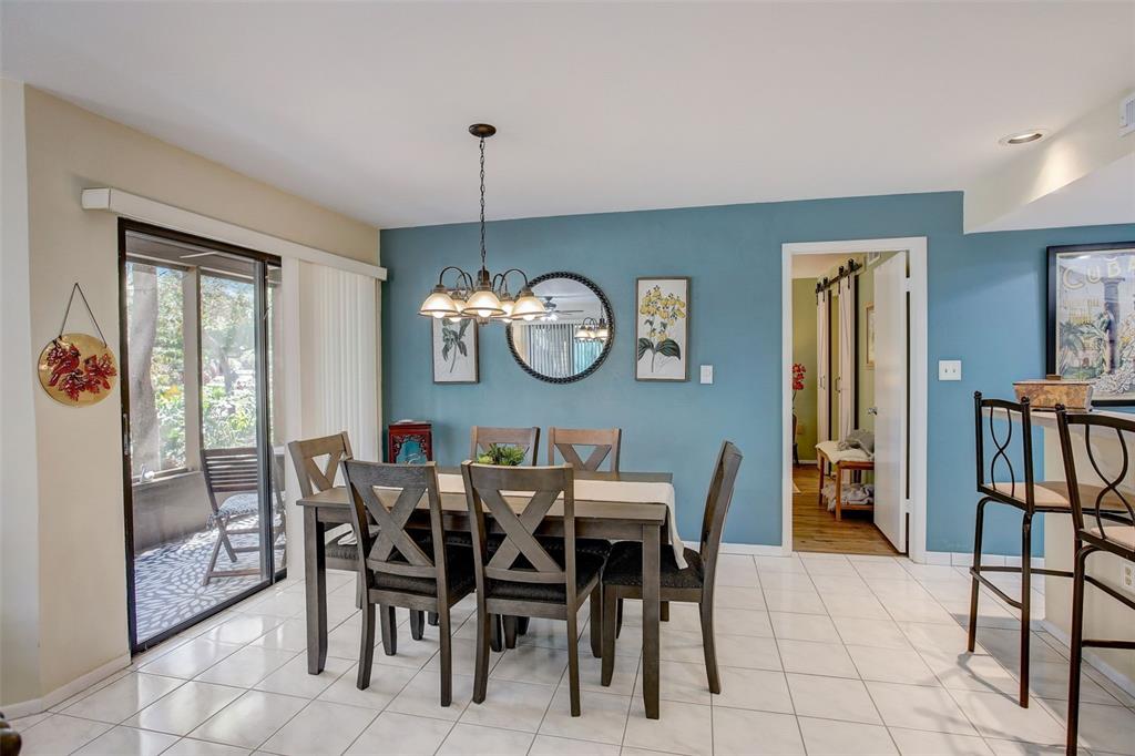 103 Cypress Pond Road, Unit 103 Palm Harbor, FL 34683 - Photo 23 of 52 a view of a dining room that has a table and chairs in it