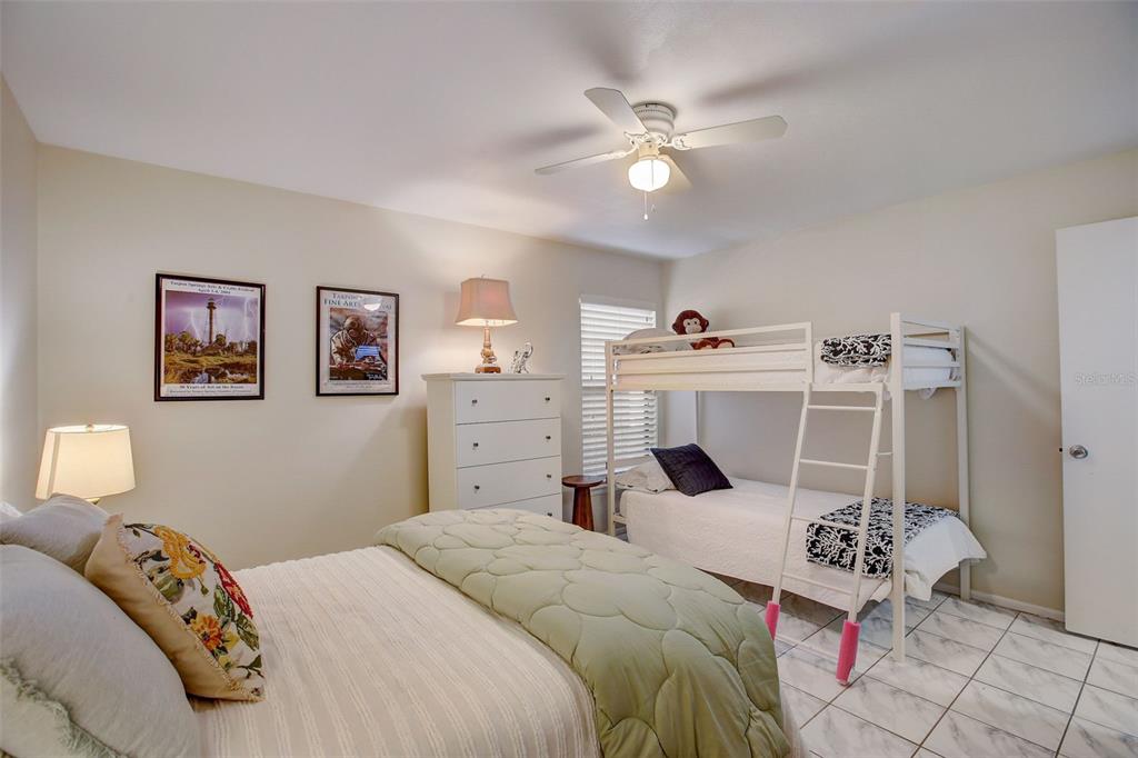 103 Cypress Pond Road, Unit 103 Palm Harbor, FL 34683 - Photo 35 of 52 a bedroom with a bed and cabinets