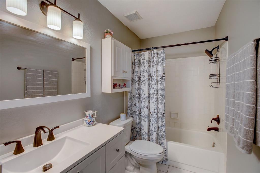 103 Cypress Pond Road, Unit 103 Palm Harbor, FL 34683 - Photo 37 of 52 a bathroom with a sink toilet a mirror and shower