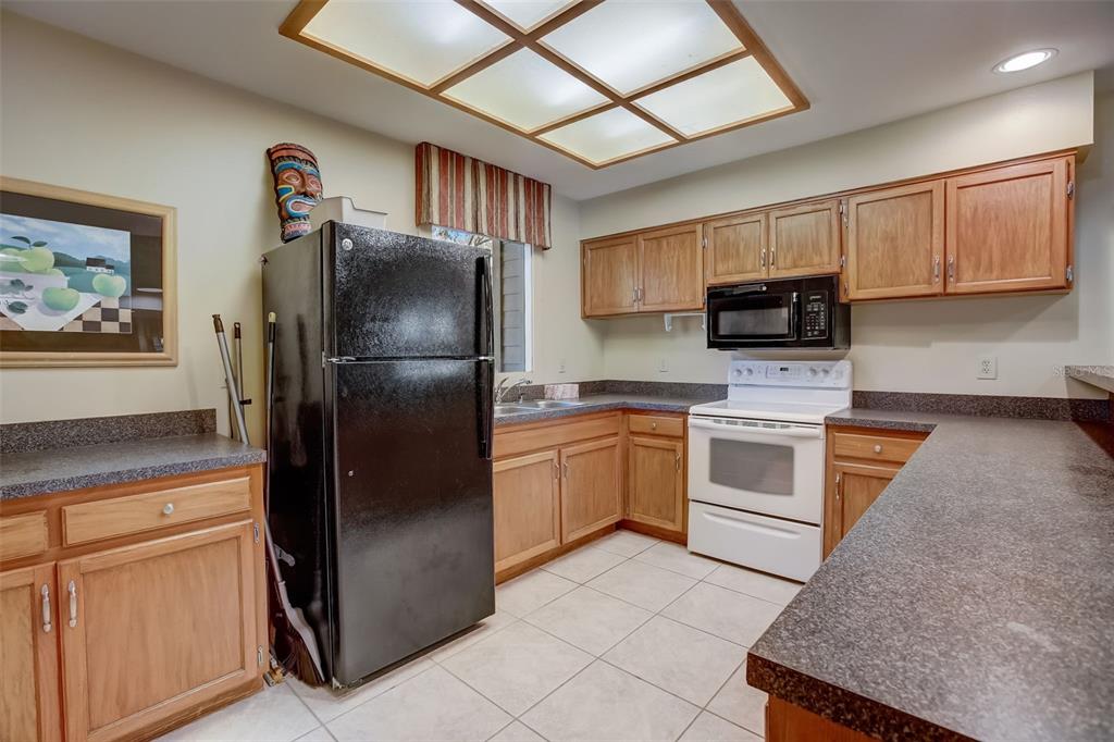 103 Cypress Pond Road, Unit 103 Palm Harbor, FL 34683 - Photo 46 of 52 a kitchen with a refrigerator stove and microwave