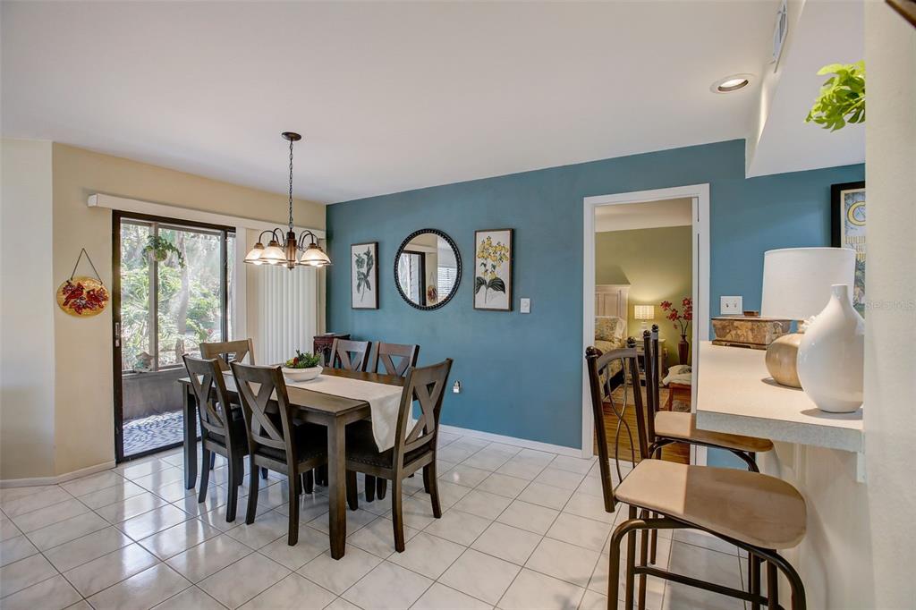 103 Cypress Pond Road, Unit 103 Palm Harbor, FL 34683 - Photo 6 of 52 a view of a dining room with furniture and chandelier