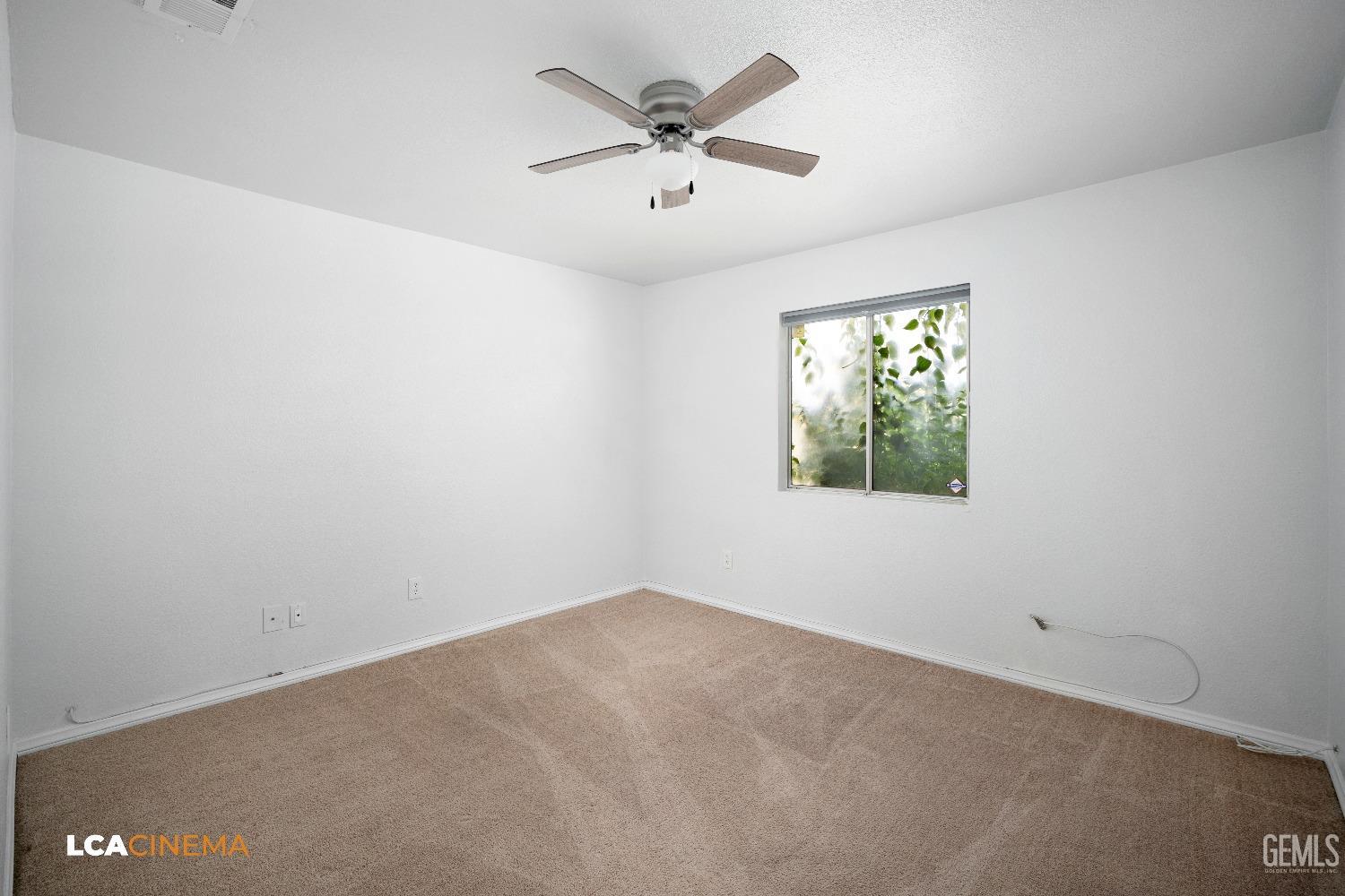 Undisclosed Address Bakersfield, CA 93305 - Photo 11 of 20 an empty room with windows and ceiling fan