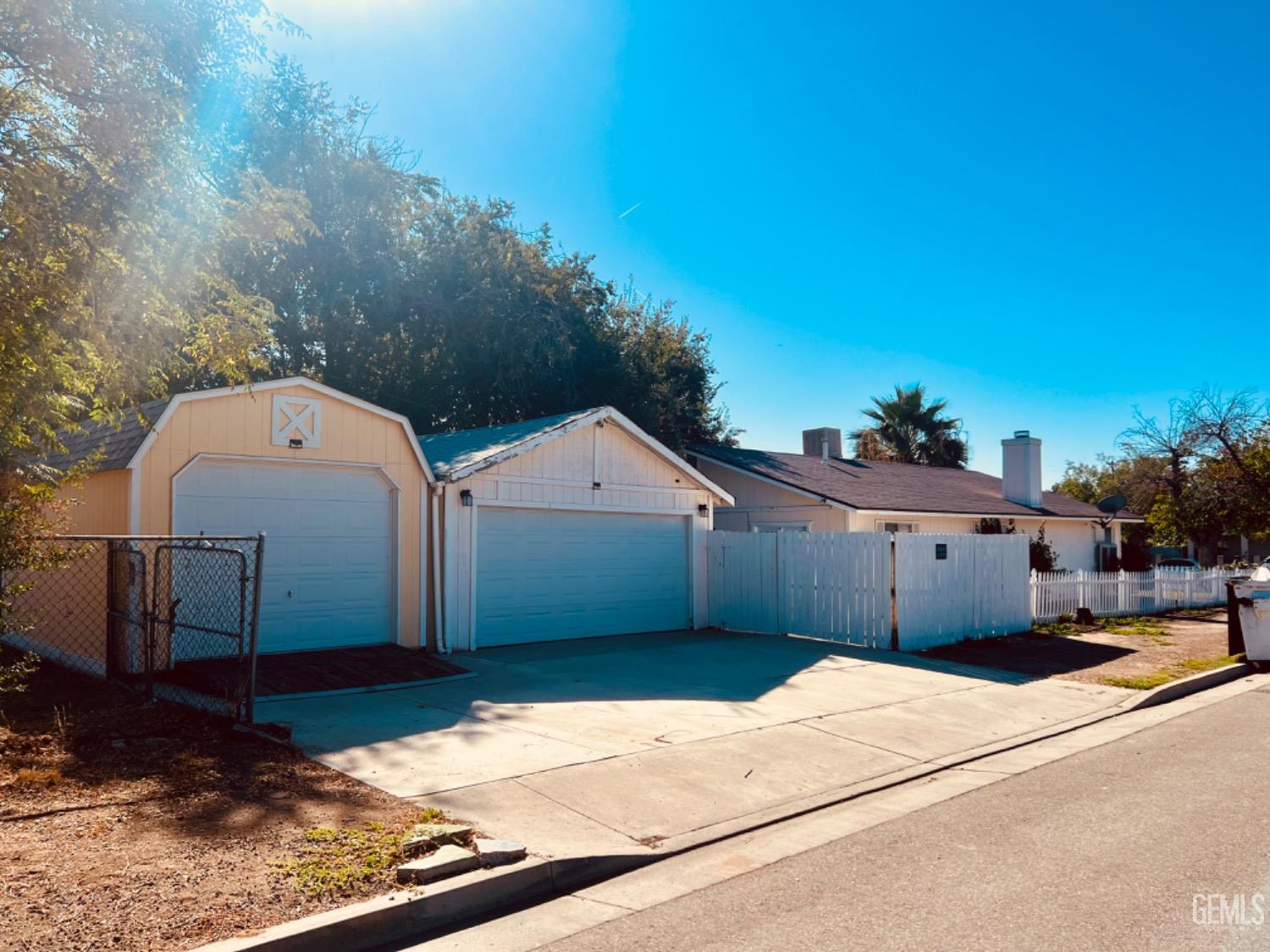 Undisclosed Address Bakersfield, CA 93305 - Photo 19 of 20 a front view of a house with a yard