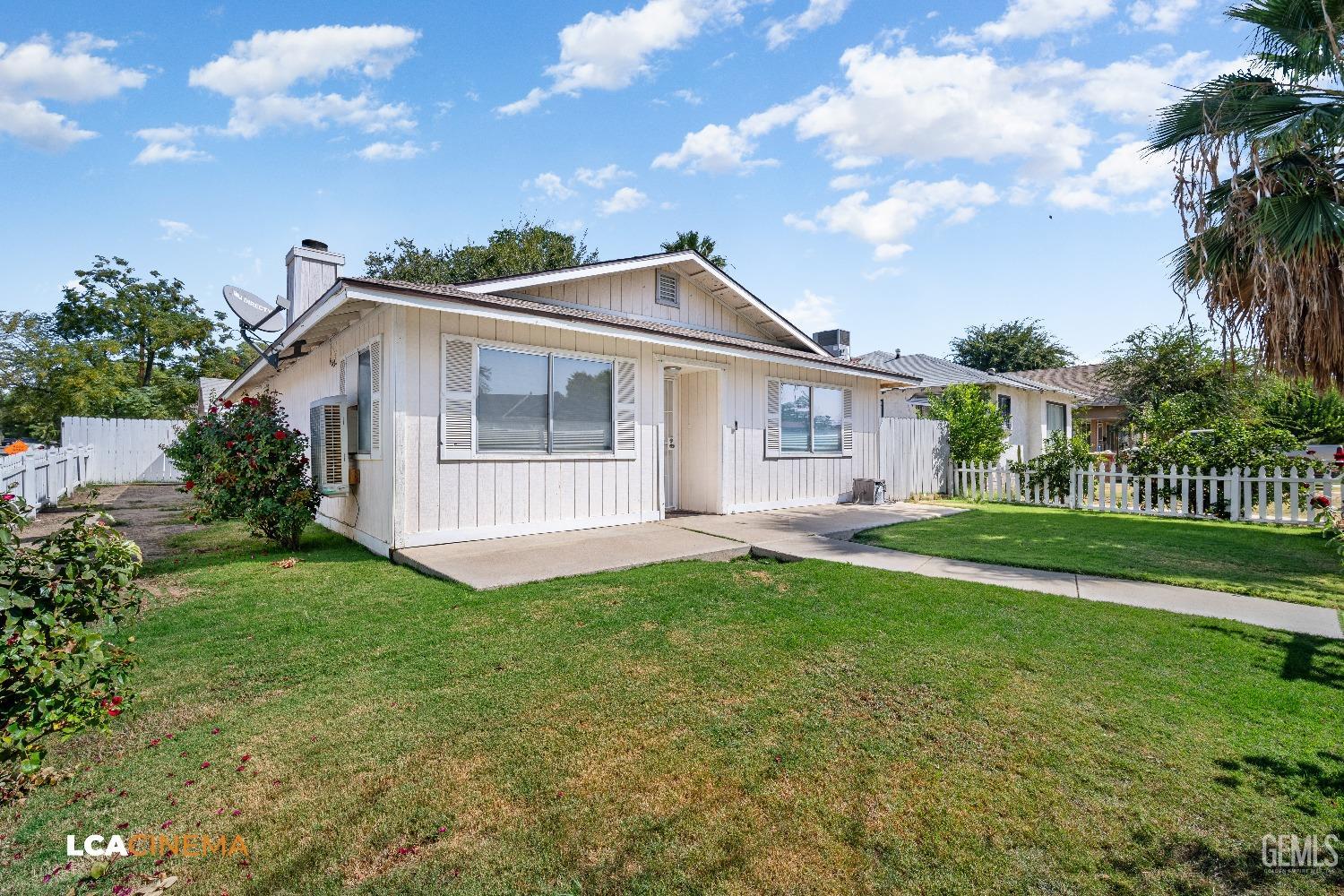 Undisclosed Address Bakersfield, CA 93305 - Photo 2 of 20 a view of a house with a yard and plants