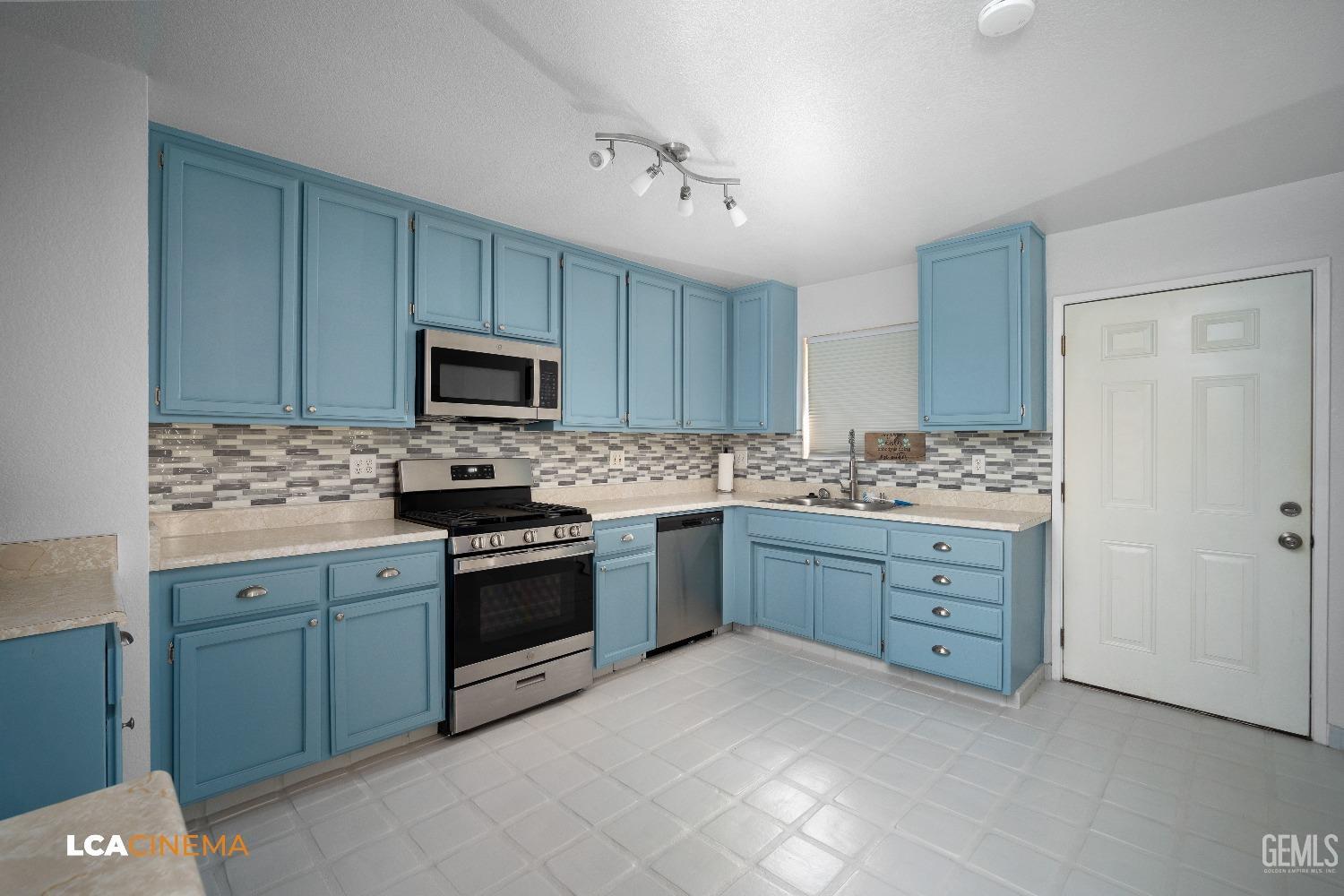 Undisclosed Address Bakersfield, CA 93305 - Photo 5 of 20 a kitchen with granite countertop a stove top oven microwave and cabinets