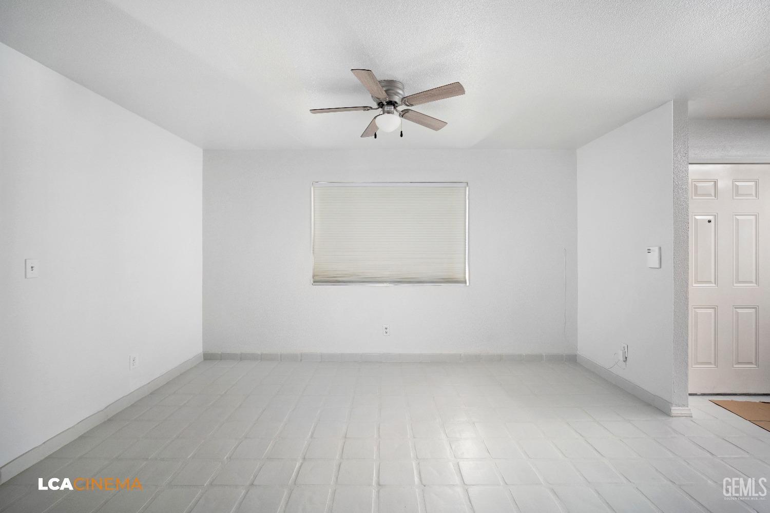 Undisclosed Address Bakersfield, CA 93305 - Photo 7 of 20 an empty room with a ceiling fan and window