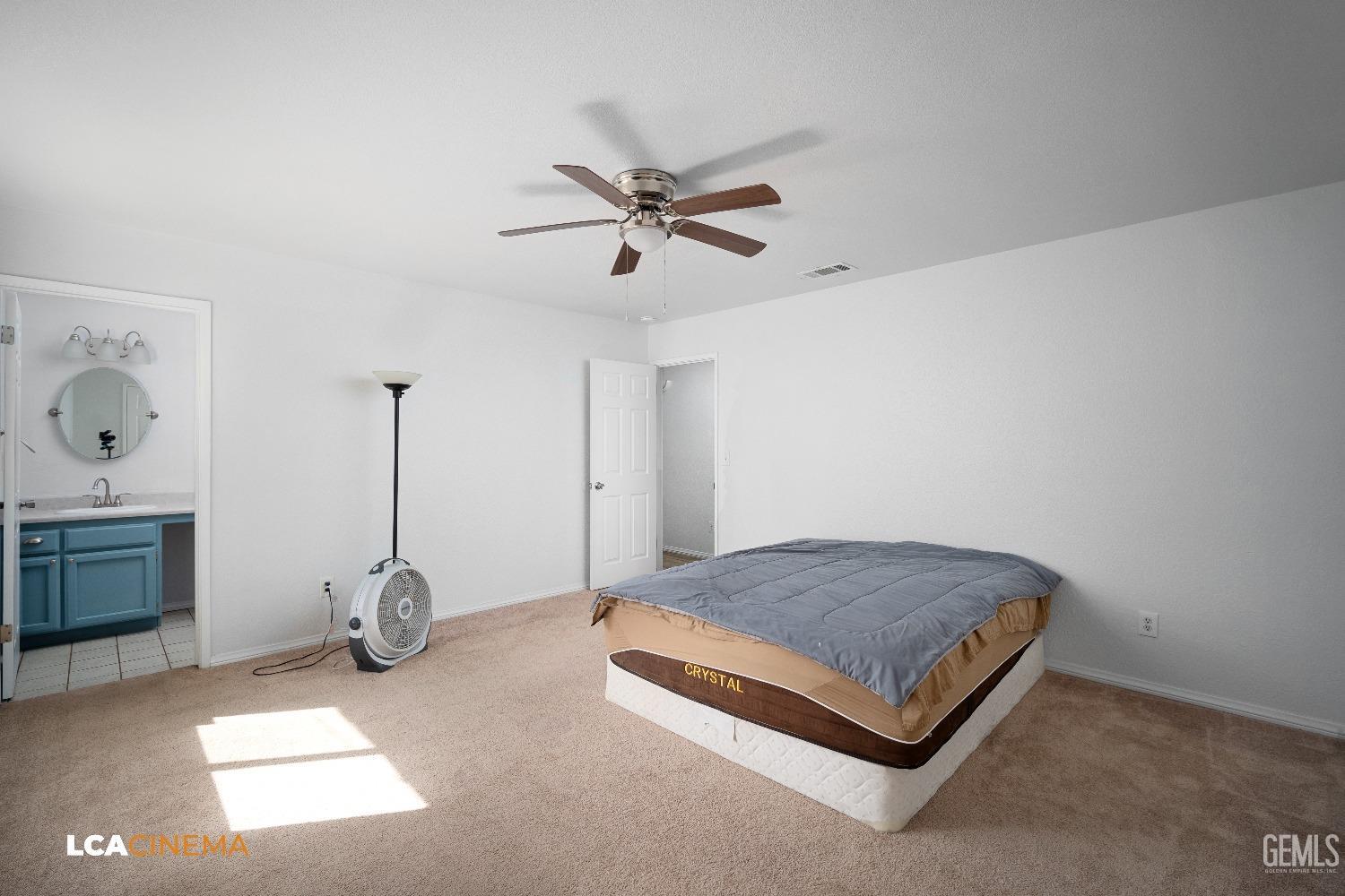 Undisclosed Address Bakersfield, CA 93305 - Photo 8 of 20 a bedroom with a bed and ceiling fan