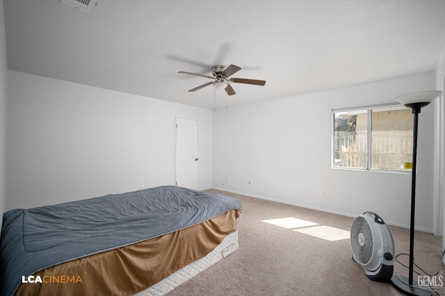 Undisclosed Address Bakersfield, CA 93305 - Photo 9 of 20 a bedroom with a bed and a chandelier
