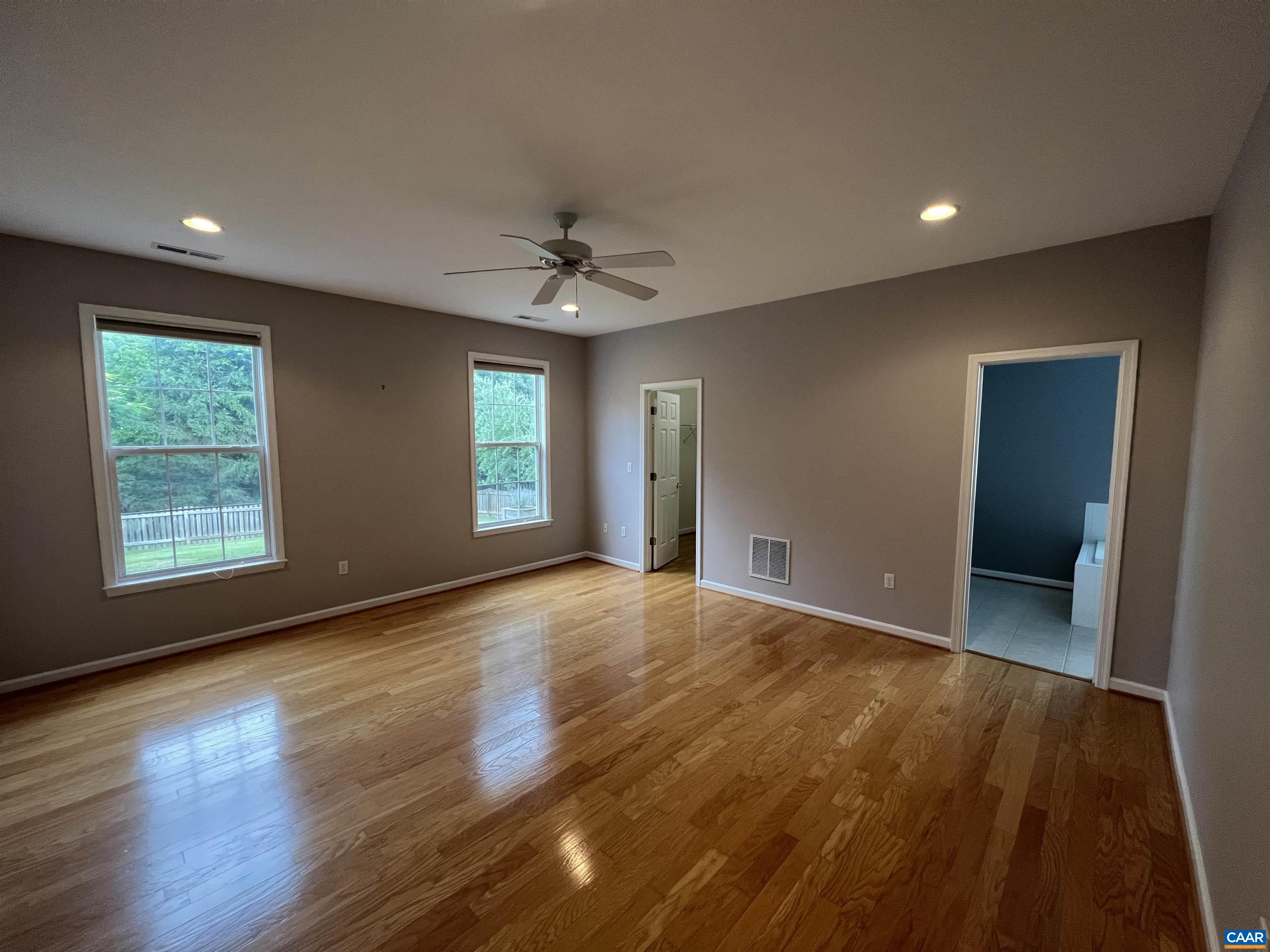 5357 Windy Ridge Road Charlottesville, VA 22903 - Photo 17 of 46 a view of an empty room with wooden floor and a window