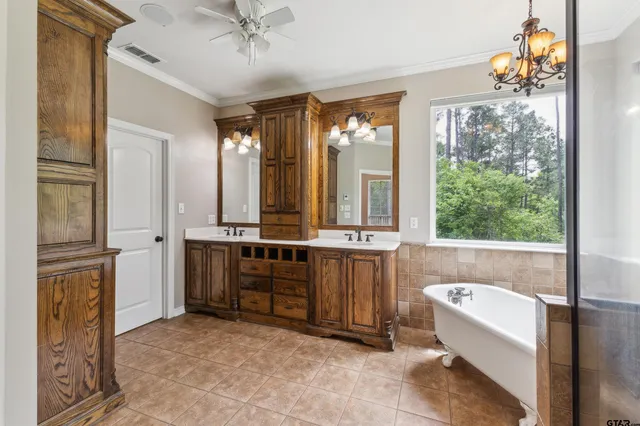 a bathroom with a tub sink and mirror